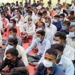 Men seated masked Meeting
